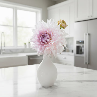 Close-up of a pink dahlia flower with green leaves in the background